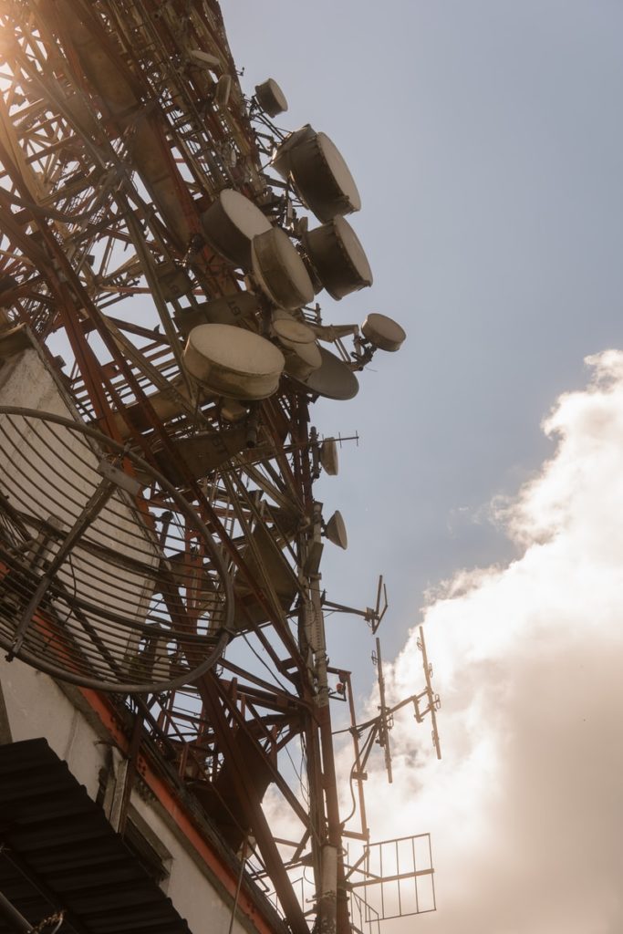 white and red ferris wheel under cloudy sky during daytime 5G