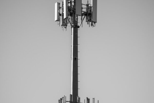 grayscale photo of black and white electric tower 5G cell towers