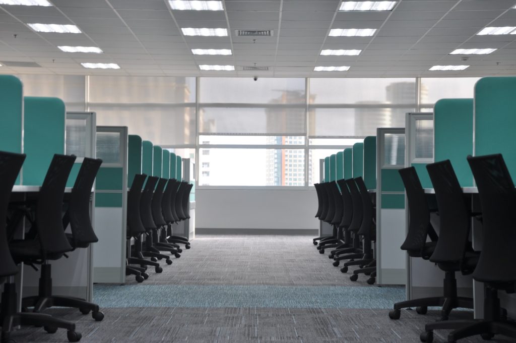empty black rolling chairs at cubicles smart node