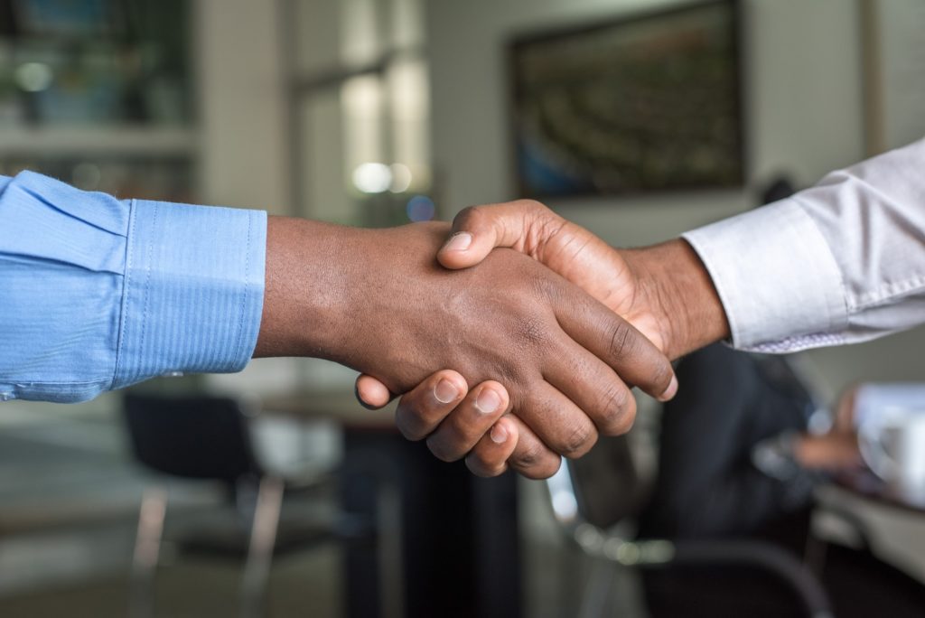 two people shaking hands like a service level agreement