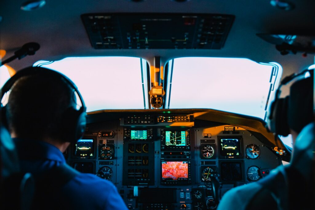 two men sitting in a cockpit FAA vs the FCC